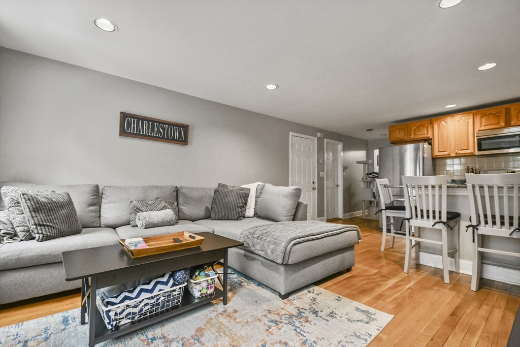 9 Allston Street, Unit 1 Boston, MA 02129 - Photo 3 of 19 a living room with furniture a rug and a large window