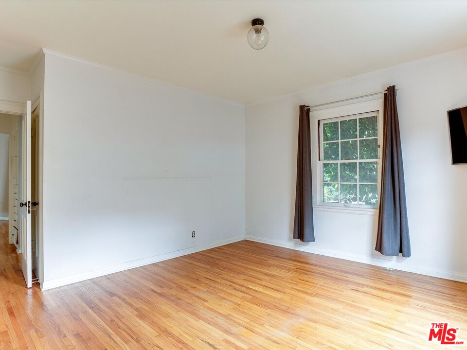 11729 Tennessee Avenue Los Angeles, CA 90064 - Photo 13 of 15 a view of empty room with wooden floor and fan