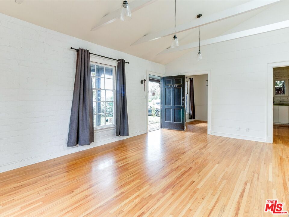 11729 Tennessee Avenue Los Angeles, CA 90064 - Photo 2 of 15 a view of an empty room with wooden floor and a window