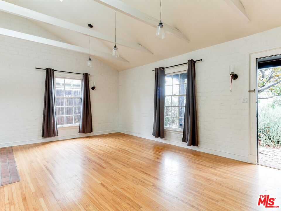 11729 Tennessee Avenue Los Angeles, CA 90064 - Photo 4 of 15 a view of an empty room with wooden floor and a window