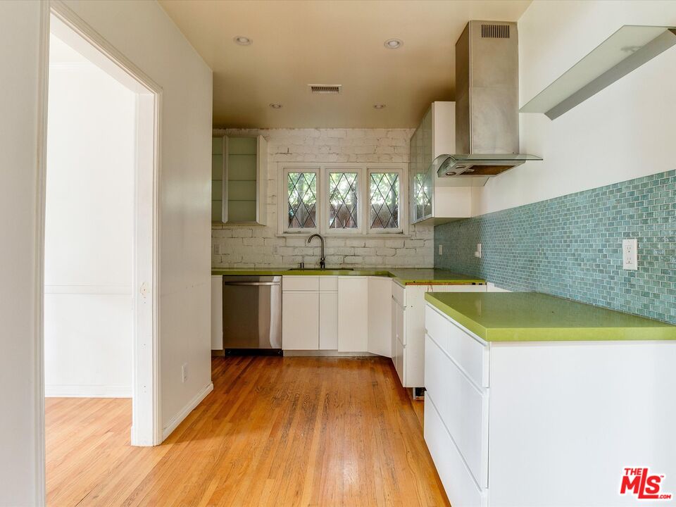 11729 Tennessee Avenue Los Angeles, CA 90064 - Photo 5 of 15 a kitchen with a sink a stove and cabinets