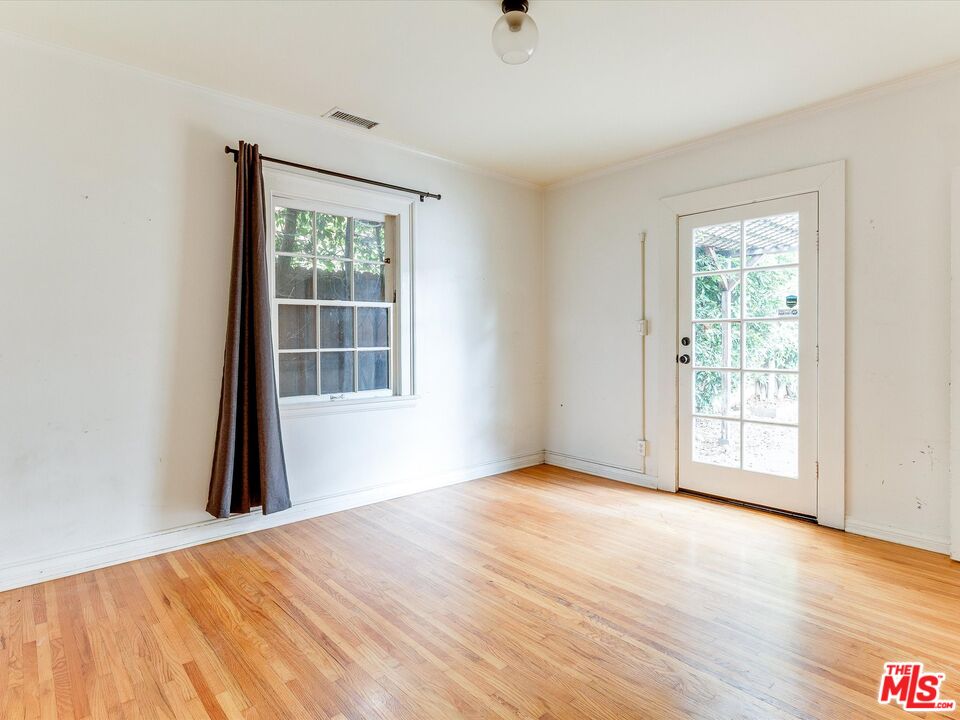 11729 Tennessee Avenue Los Angeles, CA 90064 - Photo 7 of 15 a view of an empty room with wooden floor and a window