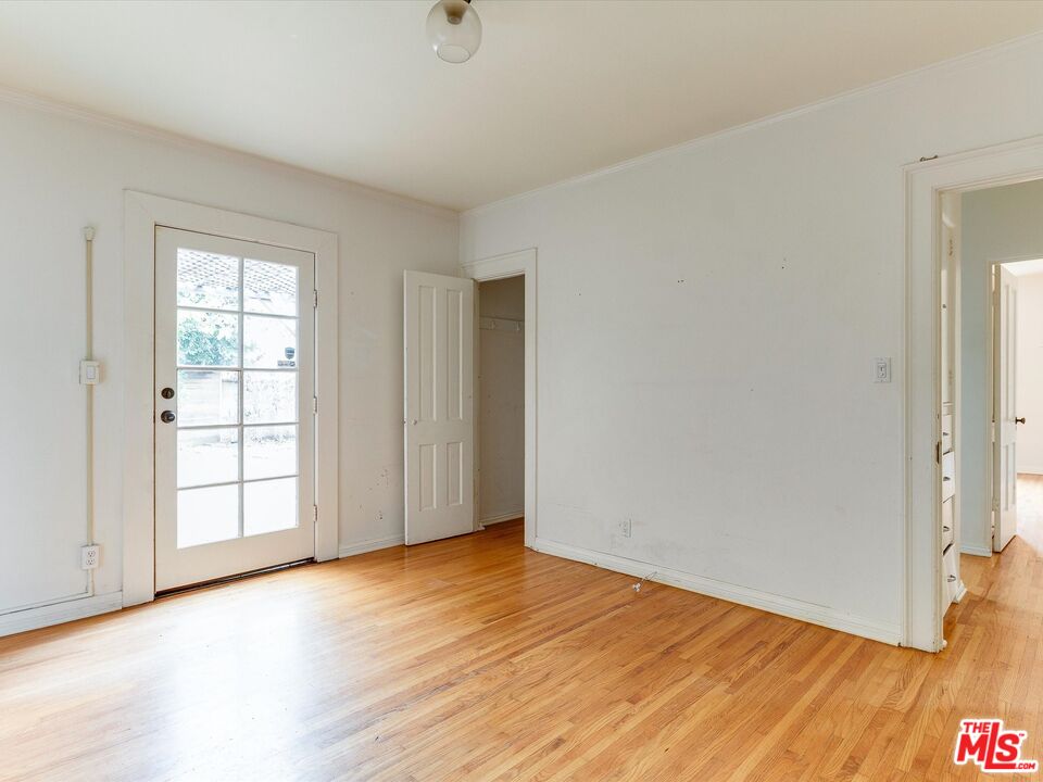 11729 Tennessee Avenue Los Angeles, CA 90064 - Photo 8 of 15 an empty room with wooden floor and windows
