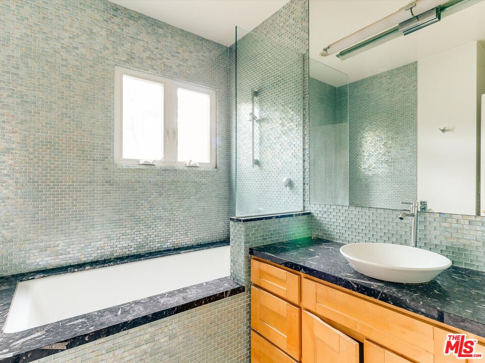 11729 Tennessee Avenue Los Angeles, CA 90064 - Photo 10 of 15 a bathroom with a granite countertop sink and a mirror