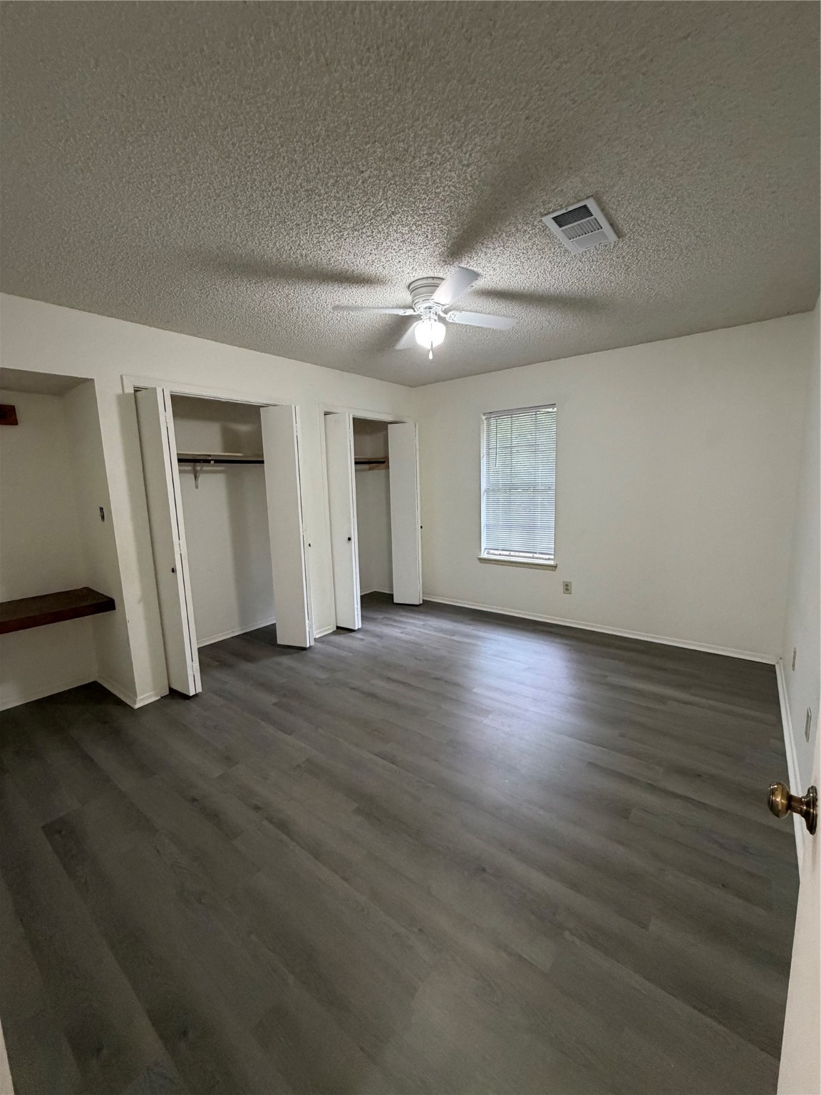 117 Kirk Road Livingston, TX 77351 - Photo 12 of 12 a view of an empty room with a window and wooden floor