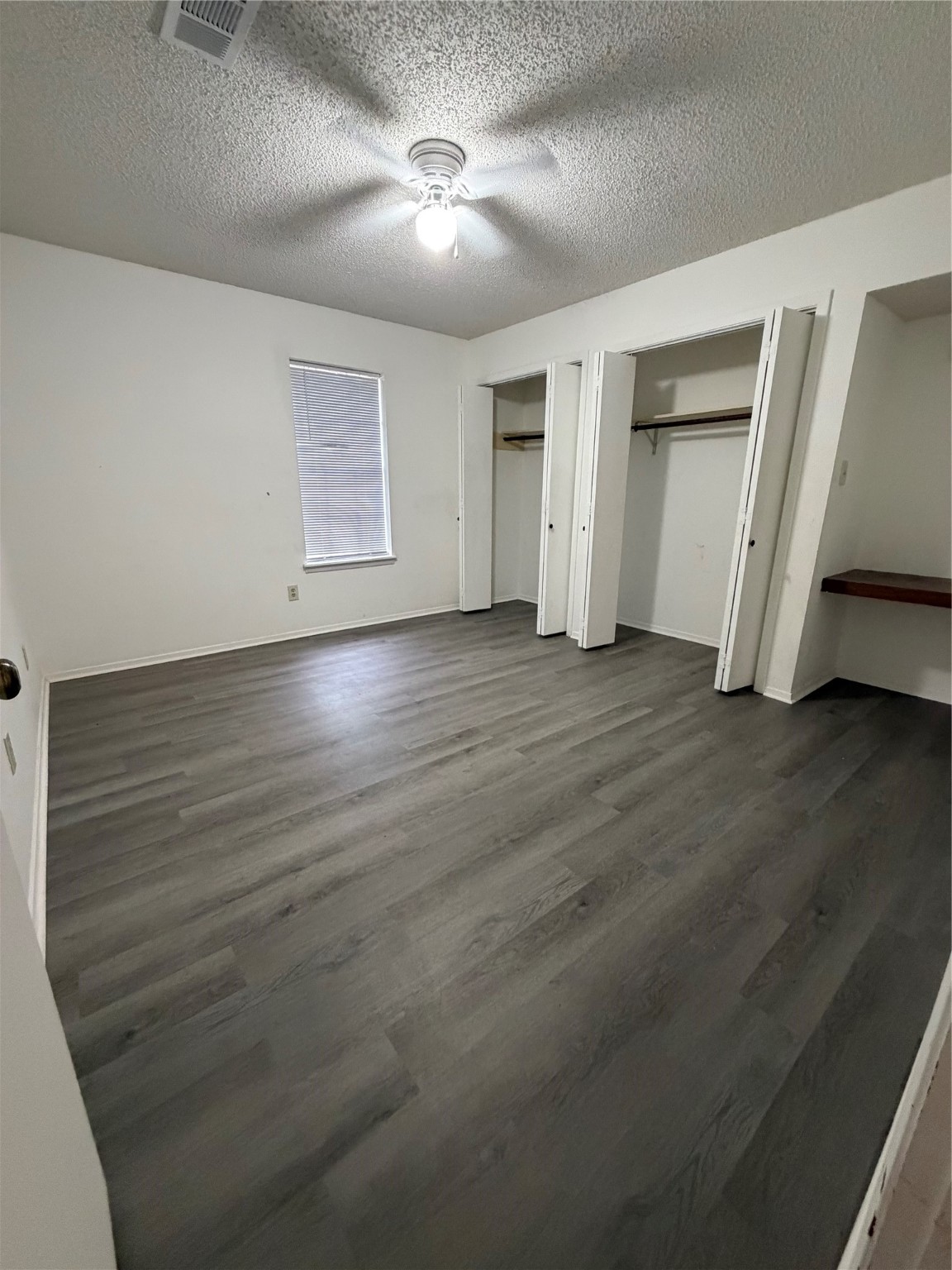 117 Kirk Road Livingston, TX 77351 - Photo 9 of 12 an empty room with wooden floor closet and windows
