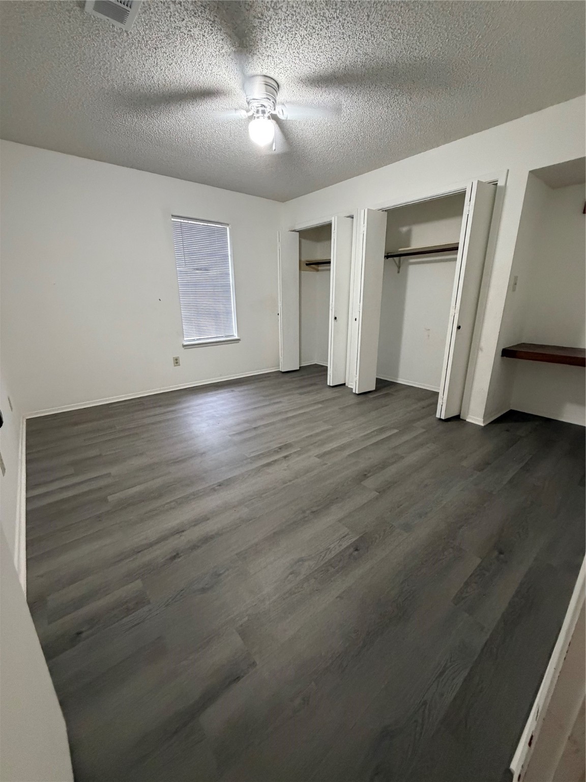 117 Kirk Road Livingston, TX 77351 - Photo 10 of 12 an empty room with wooden floor closet and windows