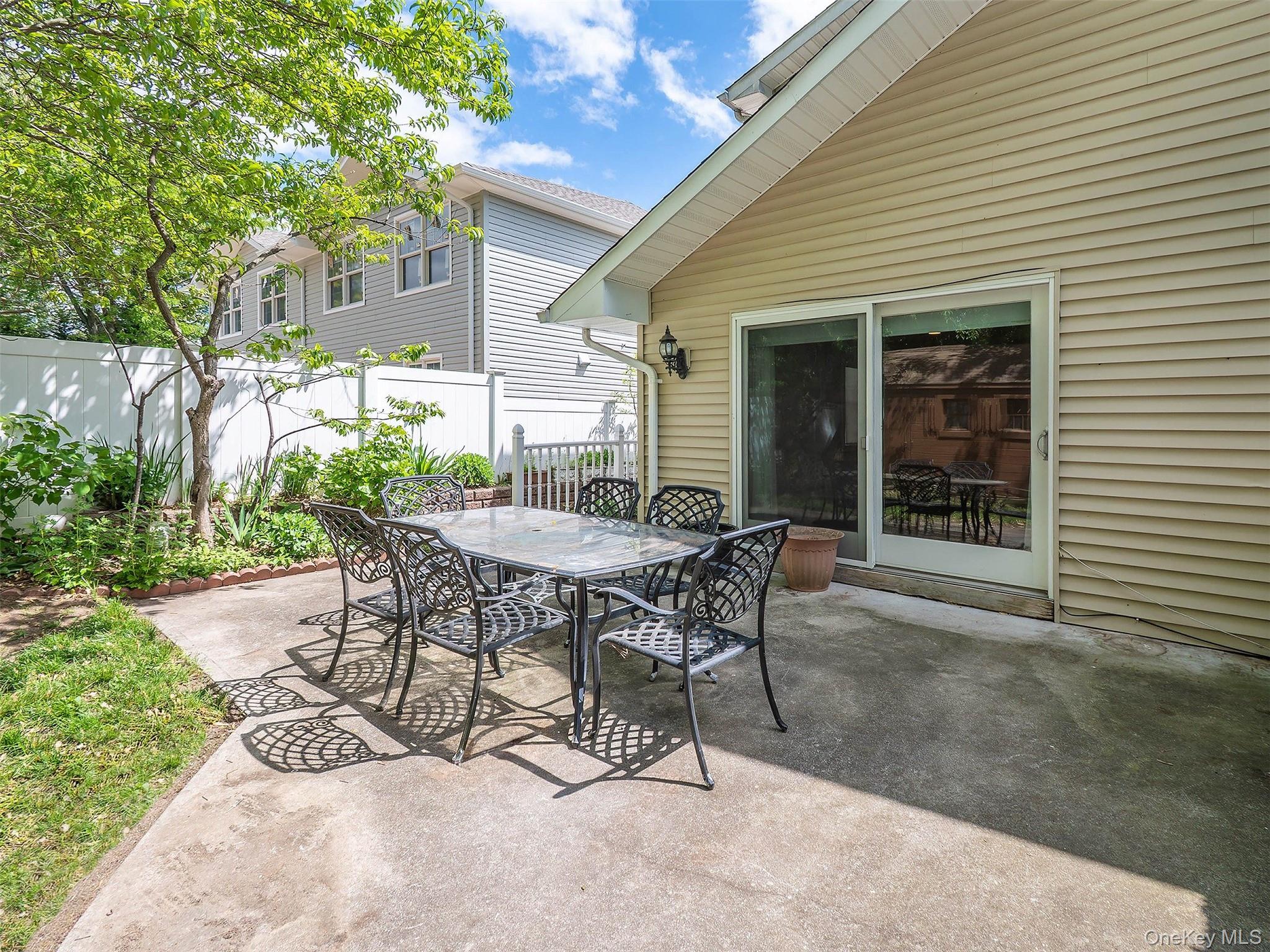 21 Marwood Road North Port Washington, NY 11050 - Photo 26 of 35 a view of a patio with table and chairs and potted plants