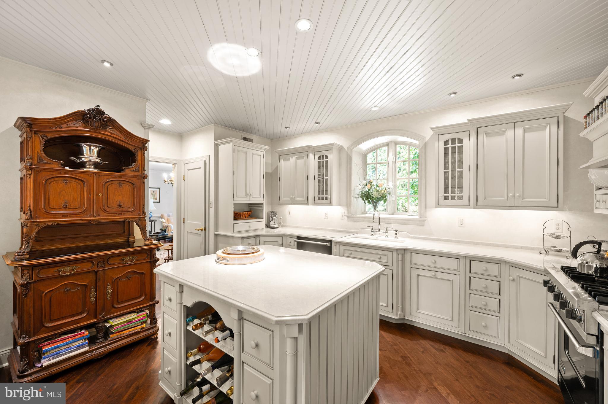 599 Longchamps Drive Wayne, PA 19087 - Photo 15 of 35 a kitchen with a sink a stove and chairs