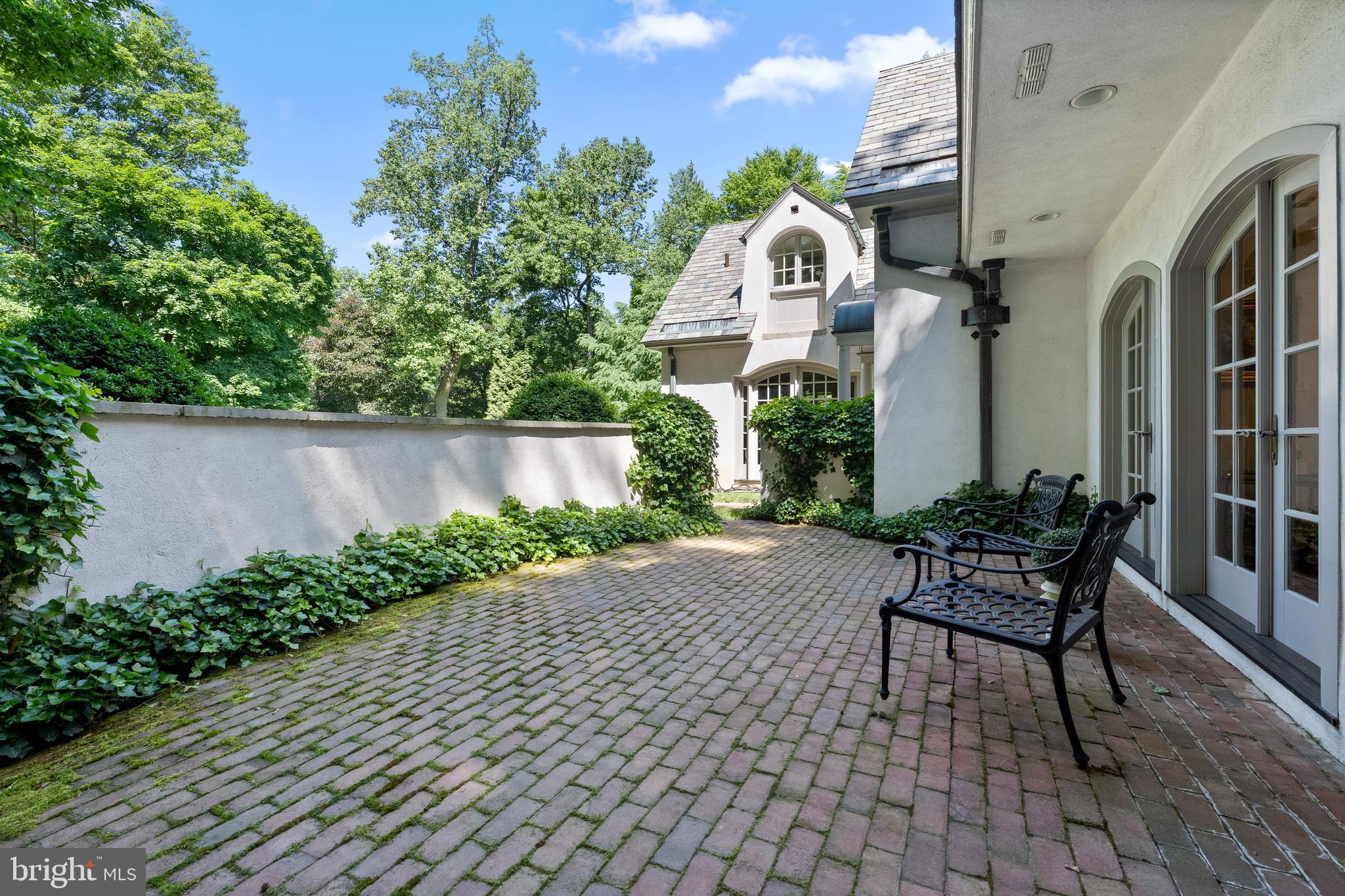 599 Longchamps Drive Wayne, PA 19087 - Photo 18 of 35 a front view of a house with a chairs and table in a patio