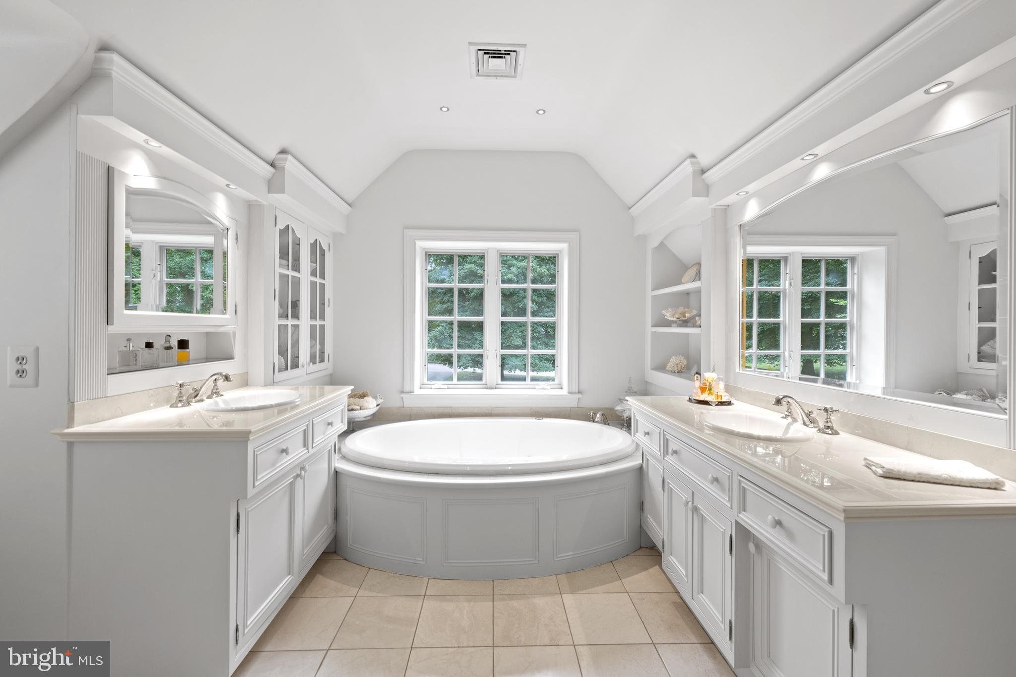 599 Longchamps Drive Wayne, PA 19087 - Photo 24 of 35 a large white bathroom with a large tub sink and window
