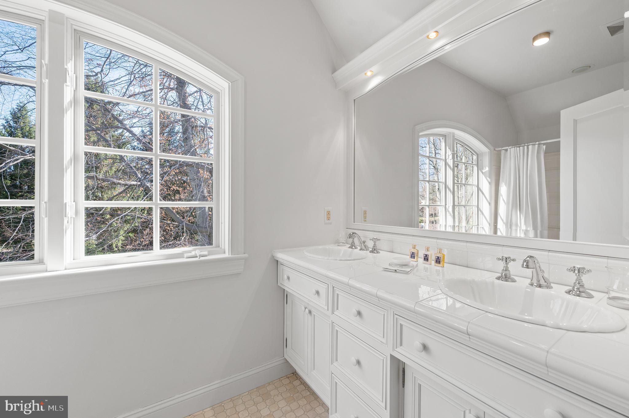 599 Longchamps Drive Wayne, PA 19087 - Photo 29 of 35 a bathroom with double sink and a window
