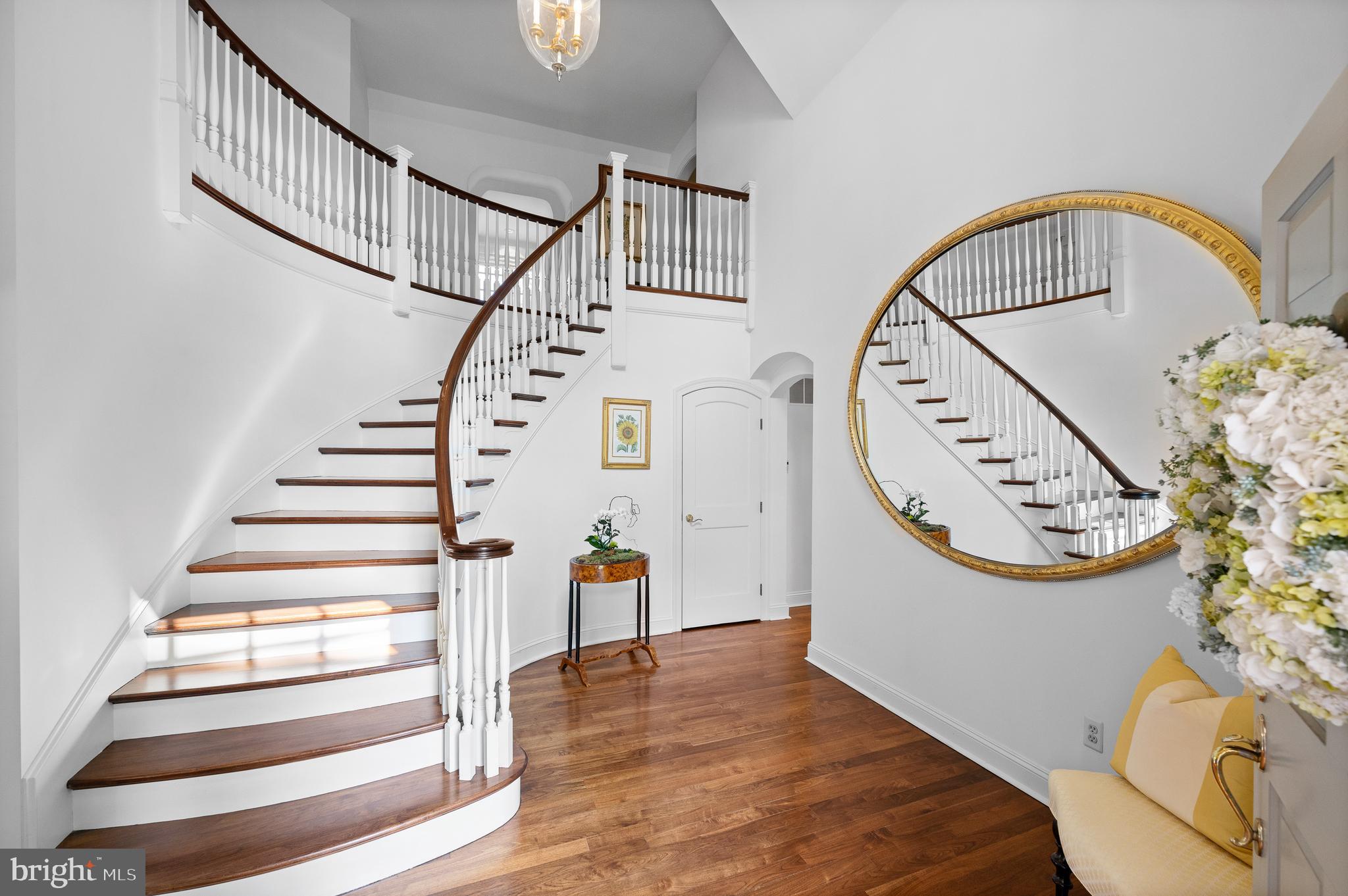 599 Longchamps Drive Wayne, PA 19087 - Photo 8 of 35 a view of staircase with white walls and a wooden floor