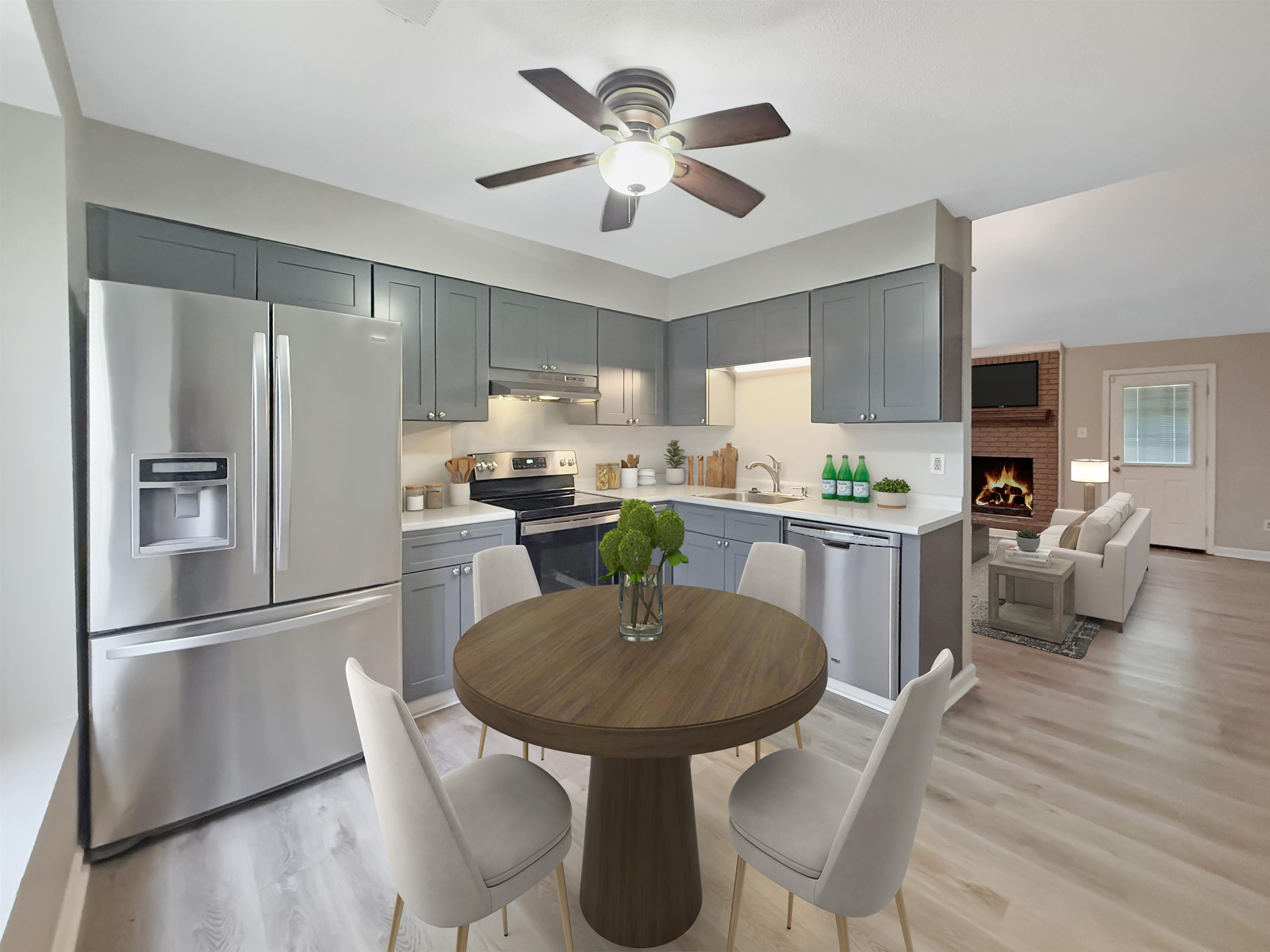 1023 Tracy Road Millington, TN 38053 - Photo 6 of 17 a kitchen with stainless steel appliances granite countertop a refrigerator a stove a sink a dining table and chairs with wooden floor