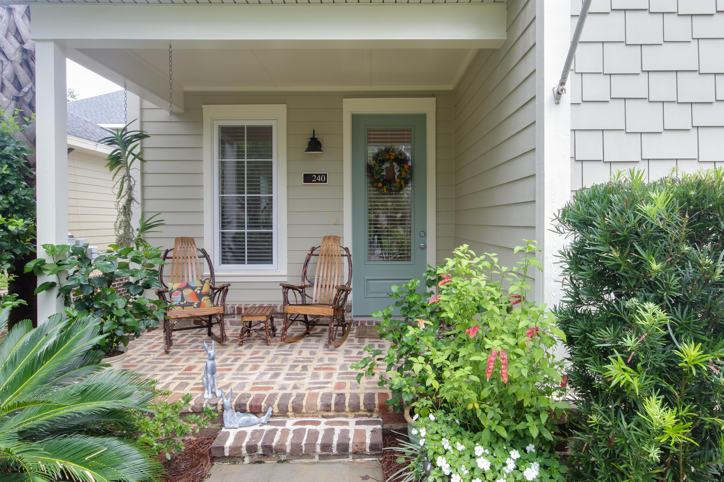 240 South Zander Way Santa Rosa Beach, FL 32459 - Photo 2 of 19 a view of a house with backyard sitting area and garden