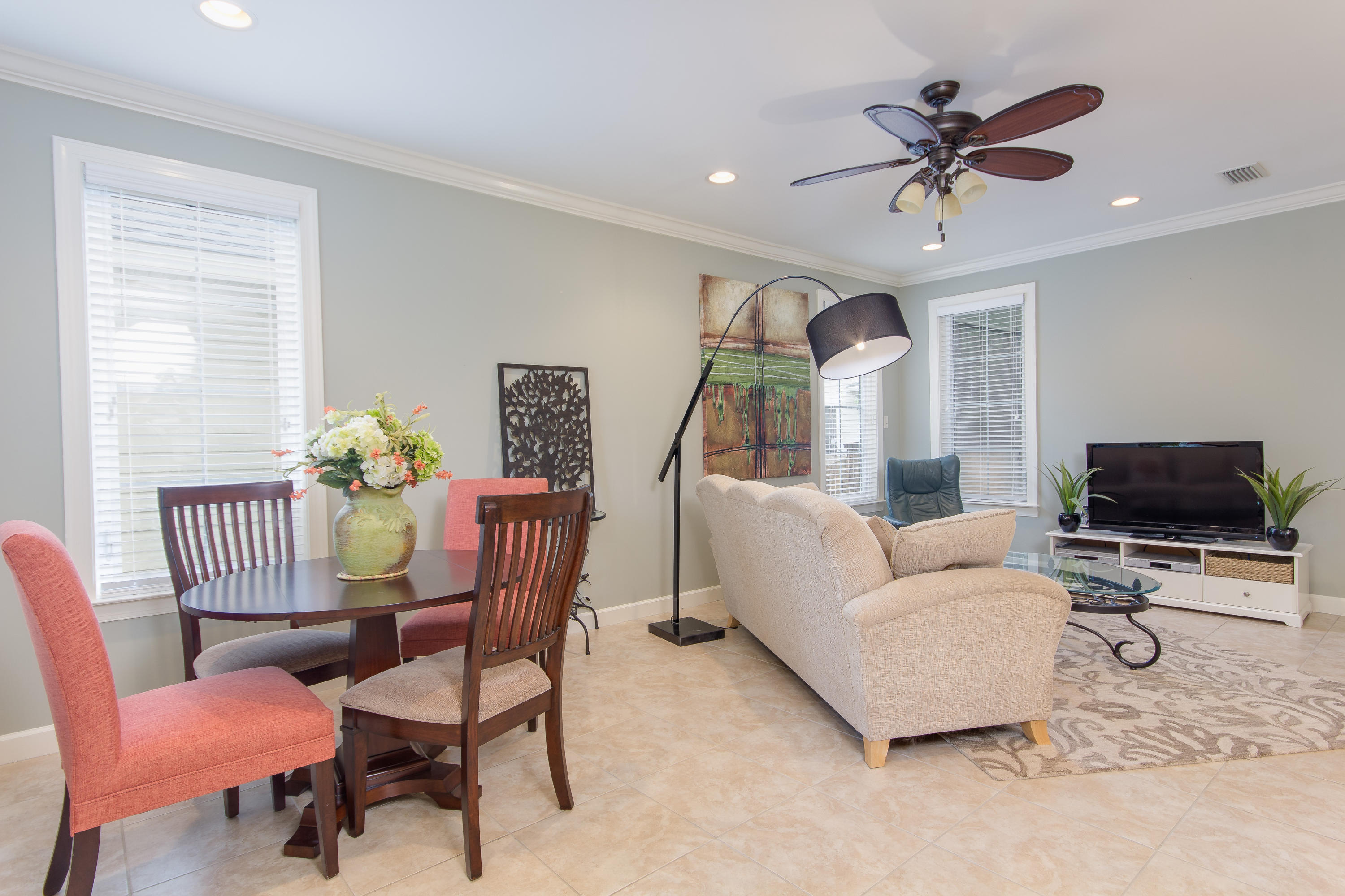 240 South Zander Way Santa Rosa Beach, FL 32459 - Photo 3 of 19 a living room with furniture a ceiling fan a flat screen tv and a window