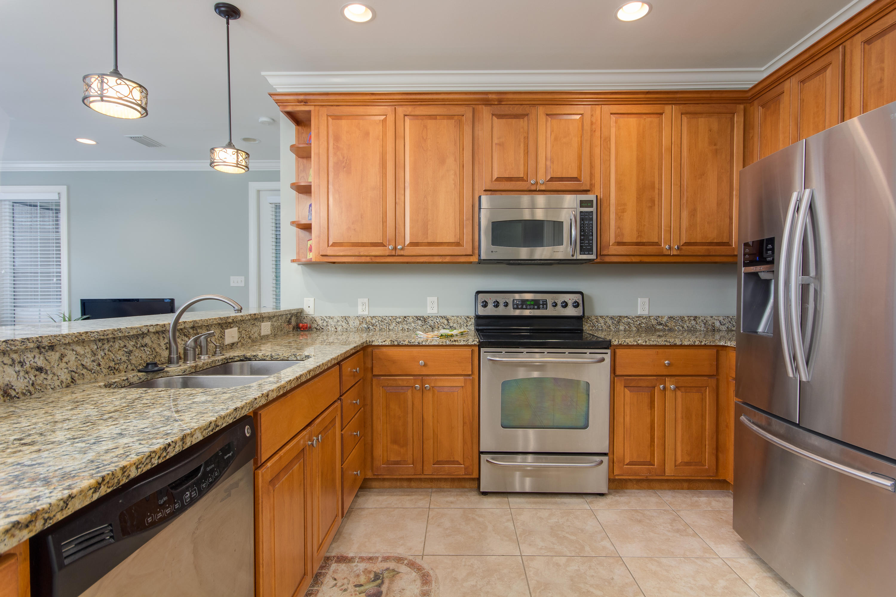 240 South Zander Way Santa Rosa Beach, FL 32459 - Photo 5 of 19 a kitchen with stainless steel appliances granite countertop a stove a sink and a refrigerator