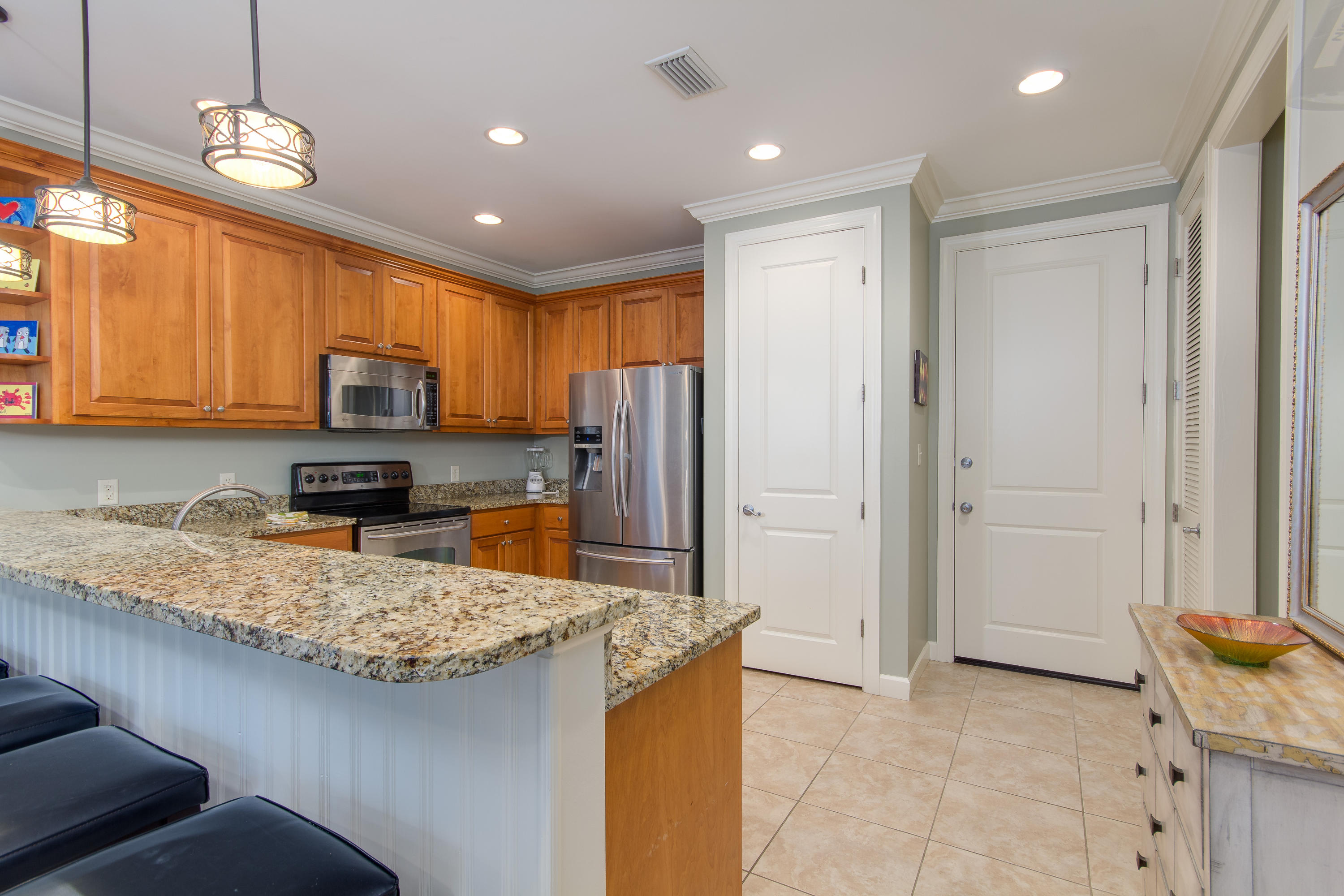 240 South Zander Way Santa Rosa Beach, FL 32459 - Photo 6 of 19 a kitchen with stainless steel appliances granite countertop a sink refrigerator and microwave