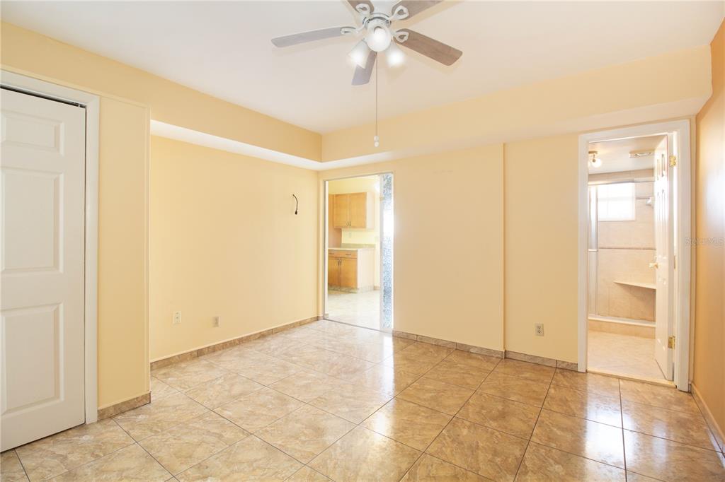 4742 Azalea Drive, Unit 203 New Port Richey, FL 34652 - Photo 14 of 32 a view of an empty room with cabinet and a ceiling fan