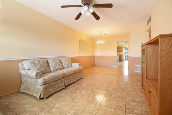 a view of a living room with a ceiling fan