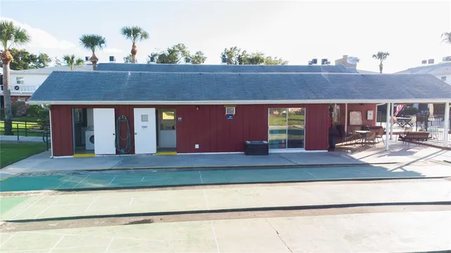 a view of house with swimming pool and chairs