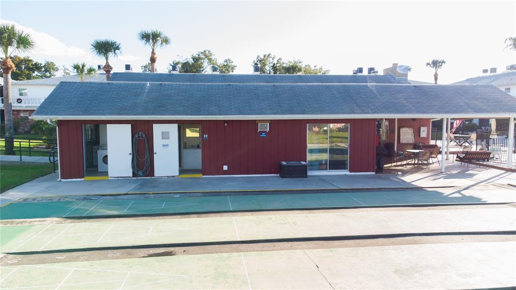 4742 Azalea Drive, Unit 203 New Port Richey, FL 34652 - Photo 30 of 32 a front view of a house with garden