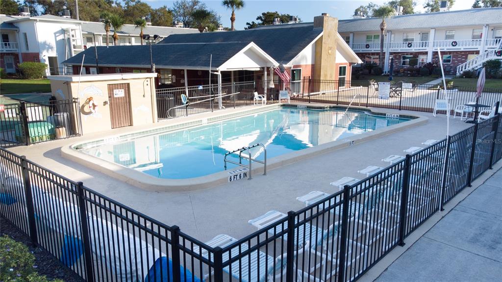 4742 Azalea Drive, Unit 203 New Port Richey, FL 34652 - Photo 31 of 32 a view of house with swimming pool and chairs