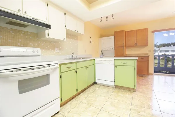 a utility room with cabinets washer and dryer