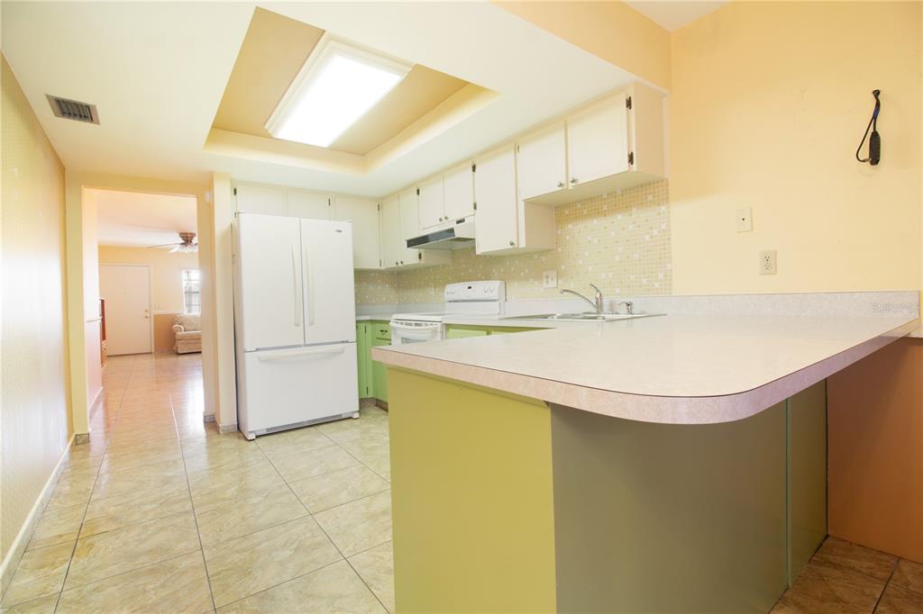 4742 Azalea Drive, Unit 203 New Port Richey, FL 34652 - Photo 7 of 32 a bathroom with a sink a mirror and a shower