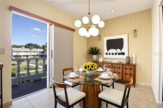 a view of a dining room with furniture a chandelier and wooden floor