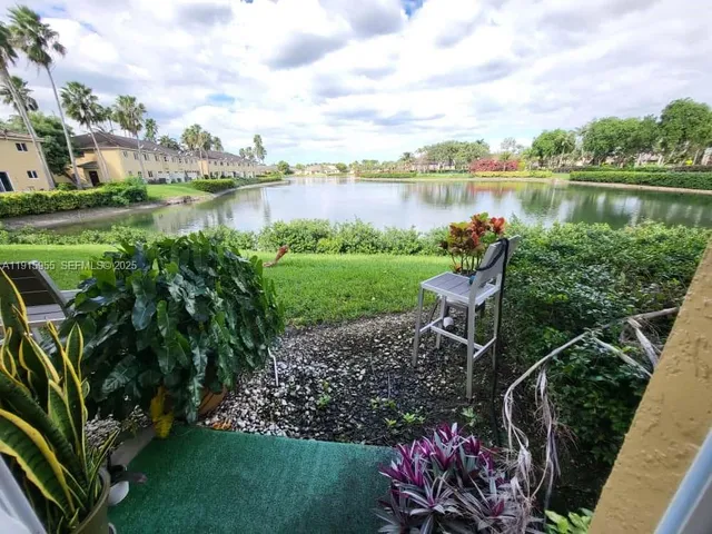 a view of a lake with a house in the background