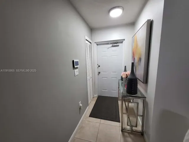 a living room with furniture and a painting on the wall