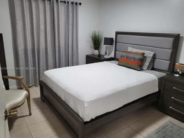 a bed sitting in a bedroom next to a window