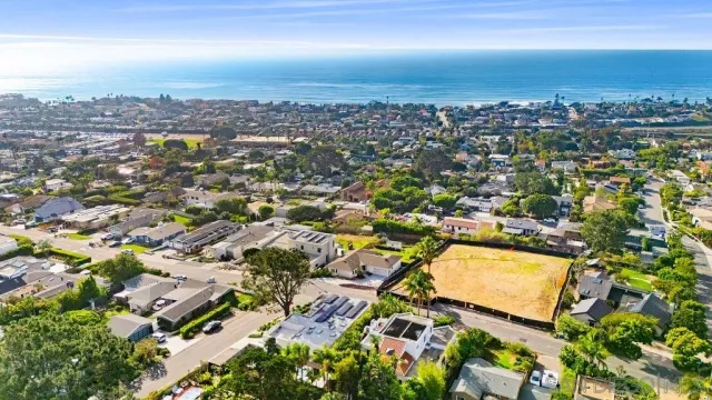 an aerial view of residential houses with city view