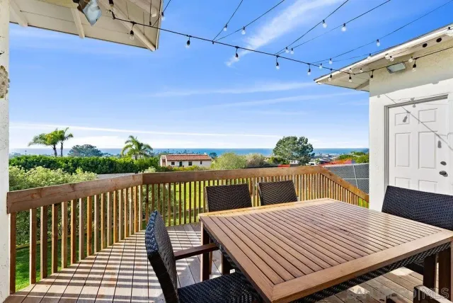 a view of a balcony with wooden floor