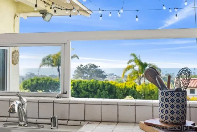 a room with a large window and outdoor seating