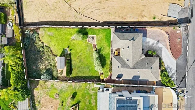 an aerial view of a house with a swimming pool