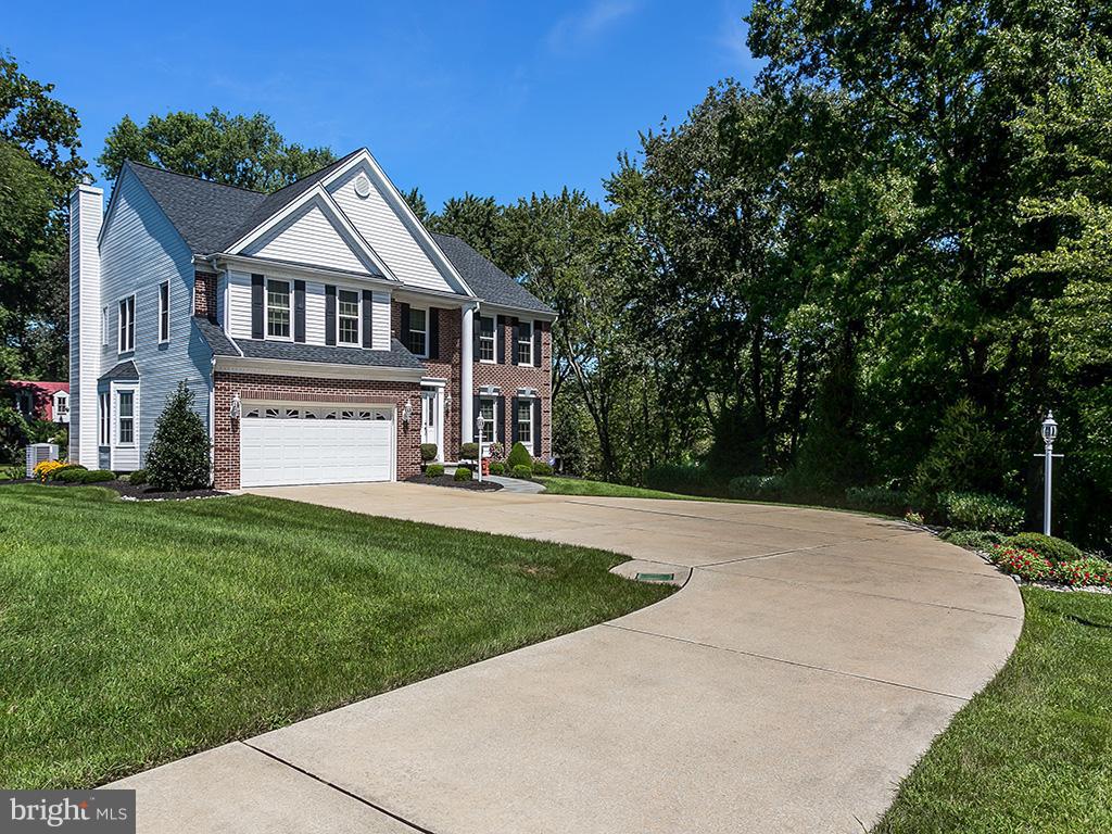 9111 Gardenia Road Baltimore, MD 21236 - Photo 2 of 30 a front view of a house with a garden and yard
