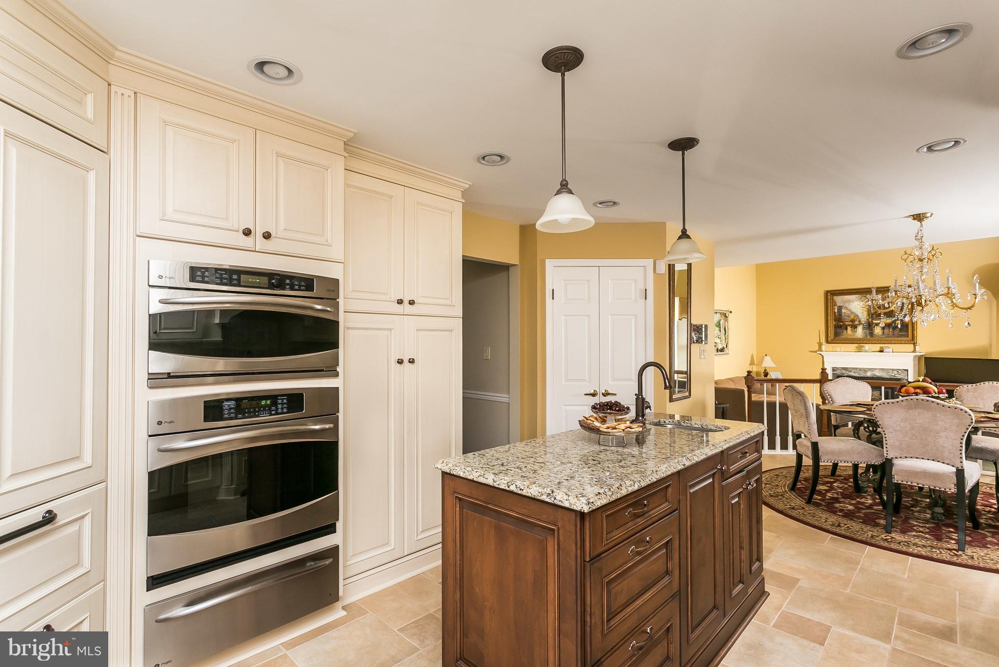 9111 Gardenia Road Baltimore, MD 21236 - Photo 12 of 30 a kitchen with a stove a sink a table and chairs