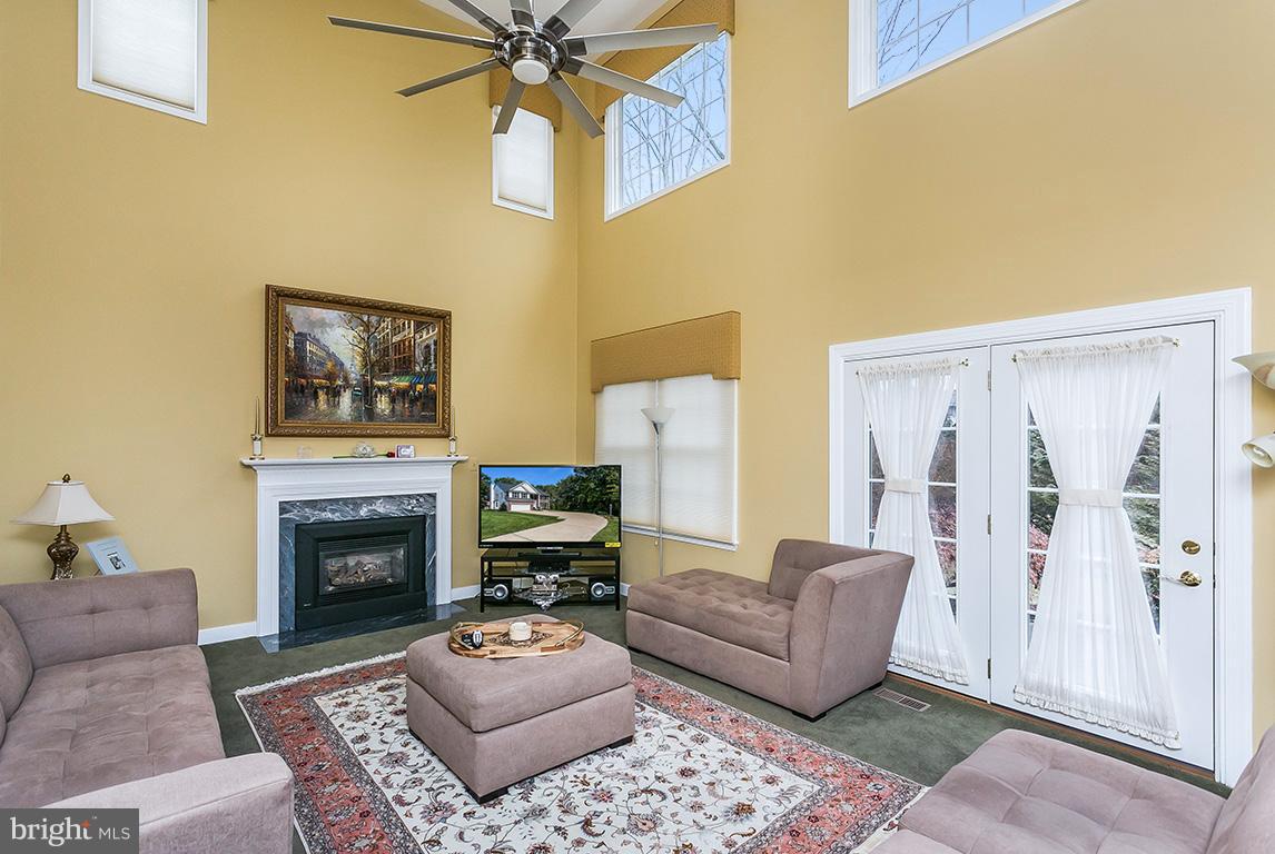 9111 Gardenia Road Baltimore, MD 21236 - Photo 14 of 30 a living room with furniture a flat screen tv and a fireplace