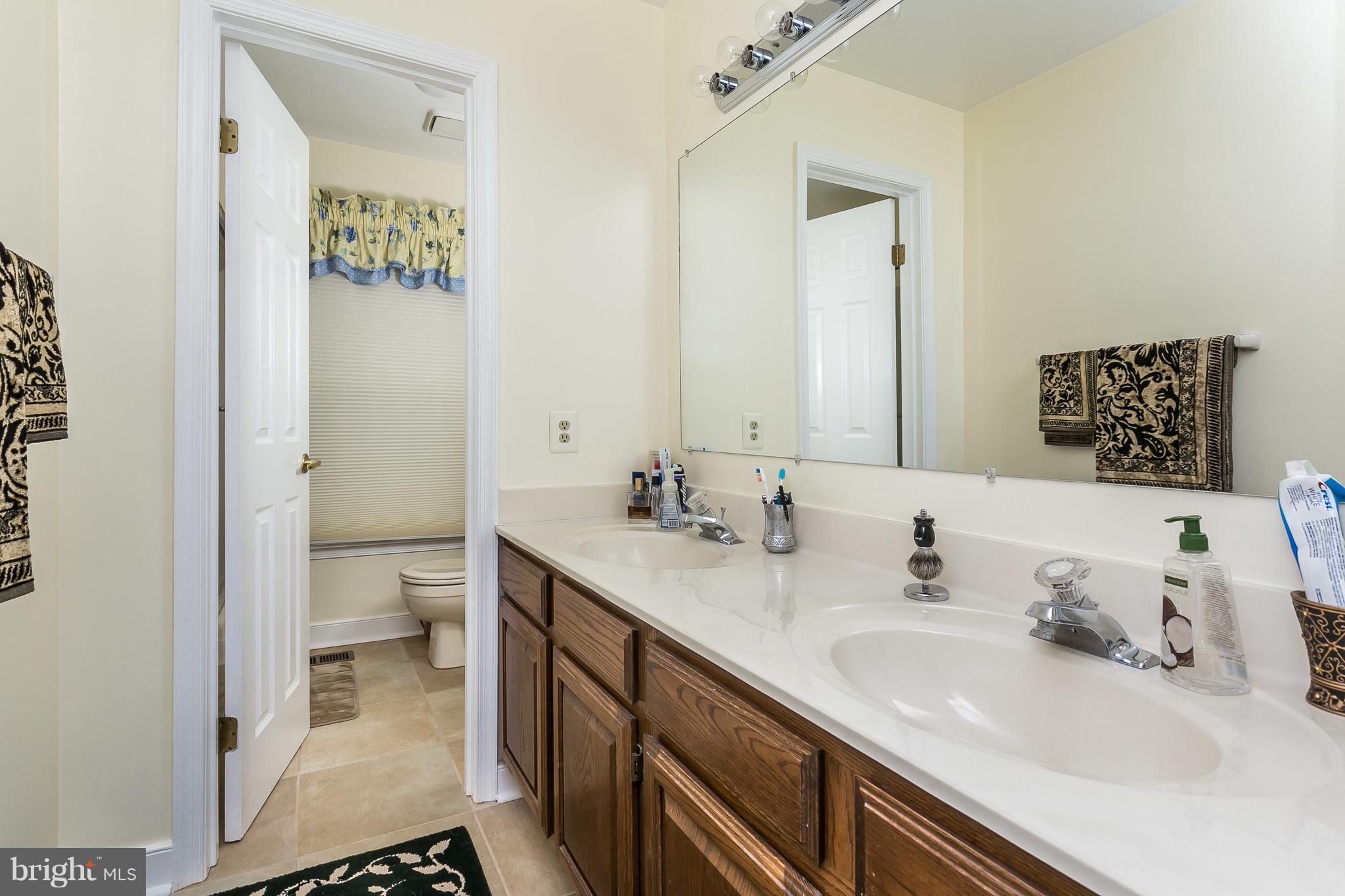 9111 Gardenia Road Baltimore, MD 21236 - Photo 21 of 30 a bathroom with a sink toilet and shower