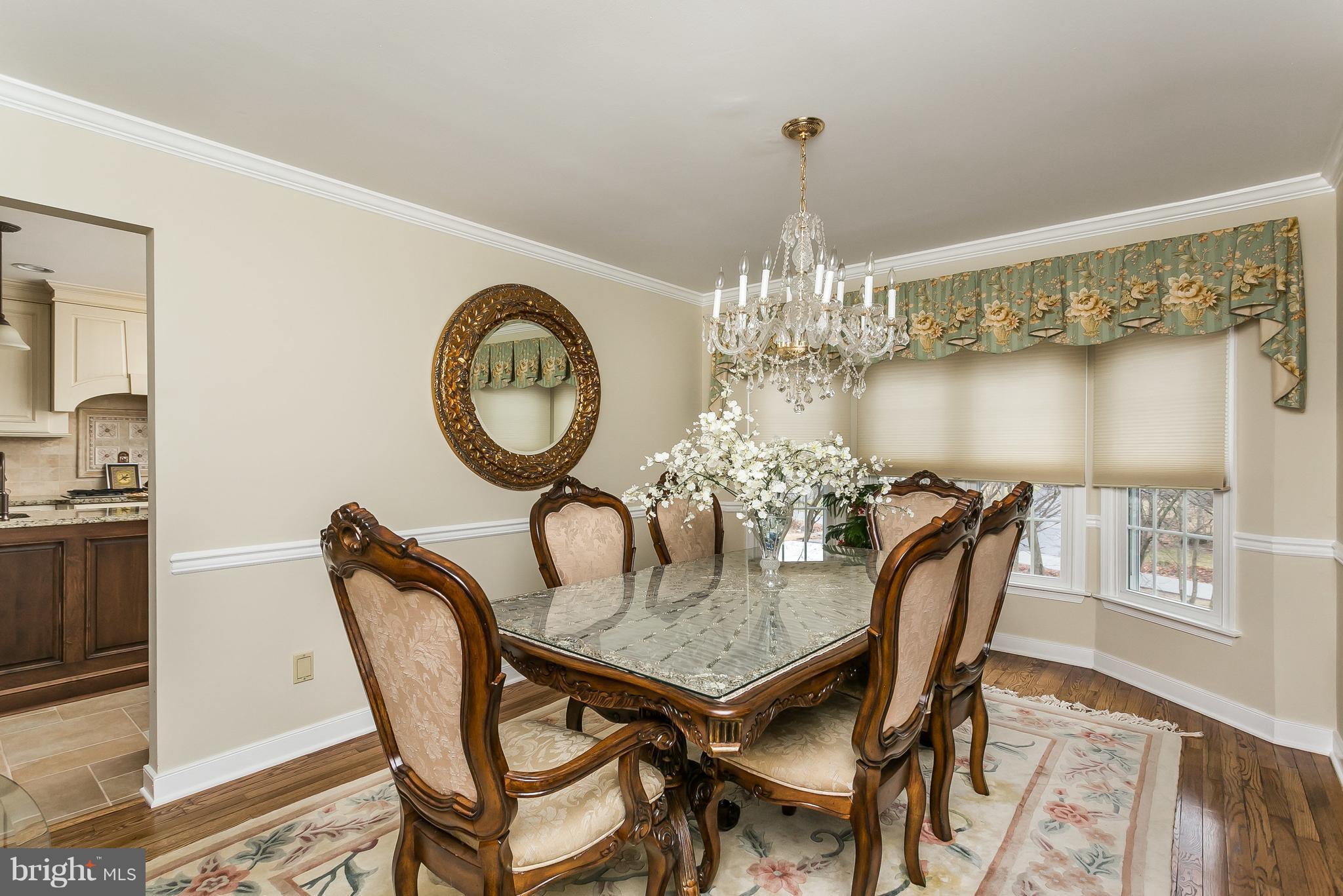 9111 Gardenia Road Baltimore, MD 21236 - Photo 8 of 30 a view of a dining room with furniture a chandelier and wooden floor