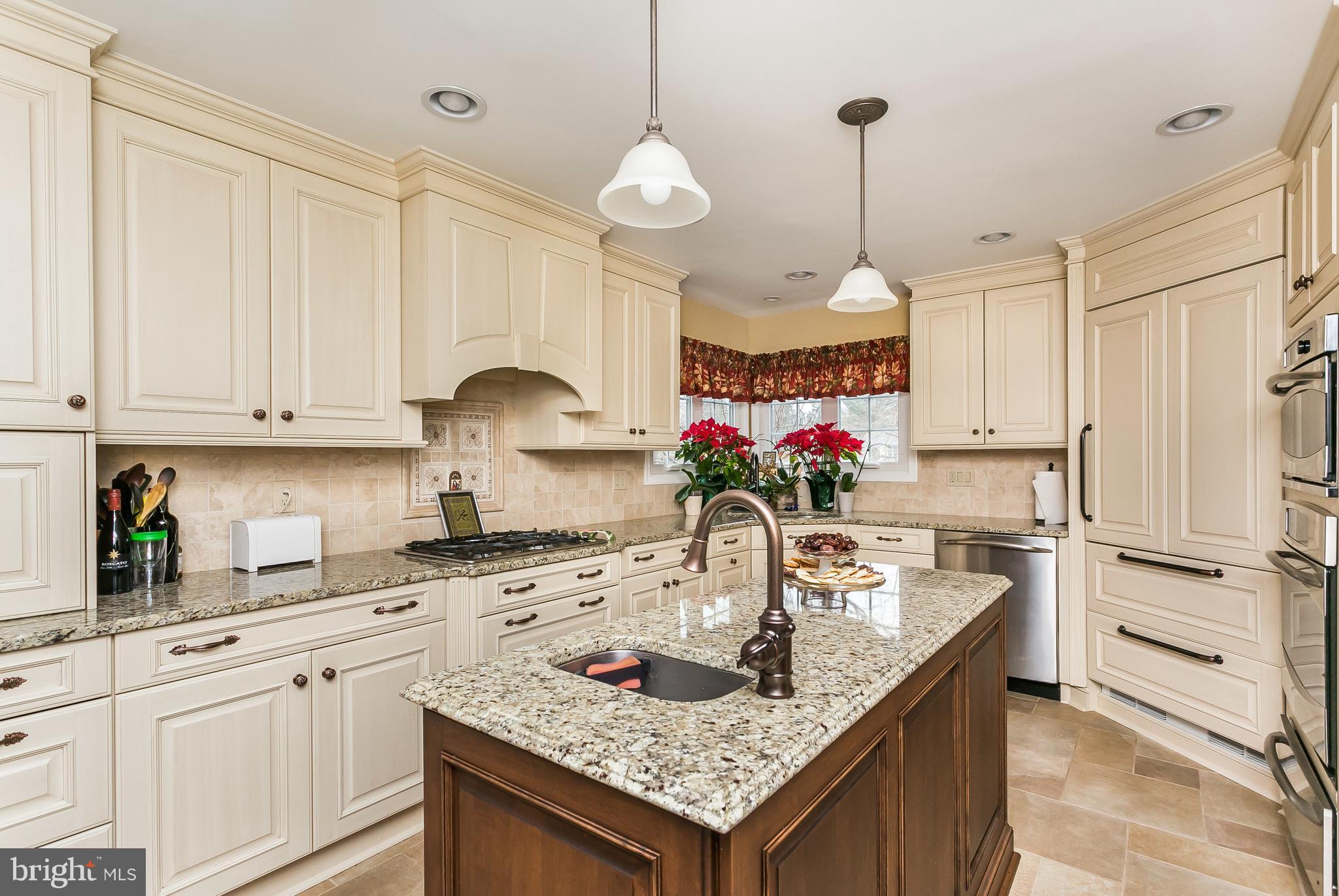 9111 Gardenia Road Baltimore, MD 21236 - Photo 9 of 30 a kitchen with granite countertop a sink a stove and cabinets