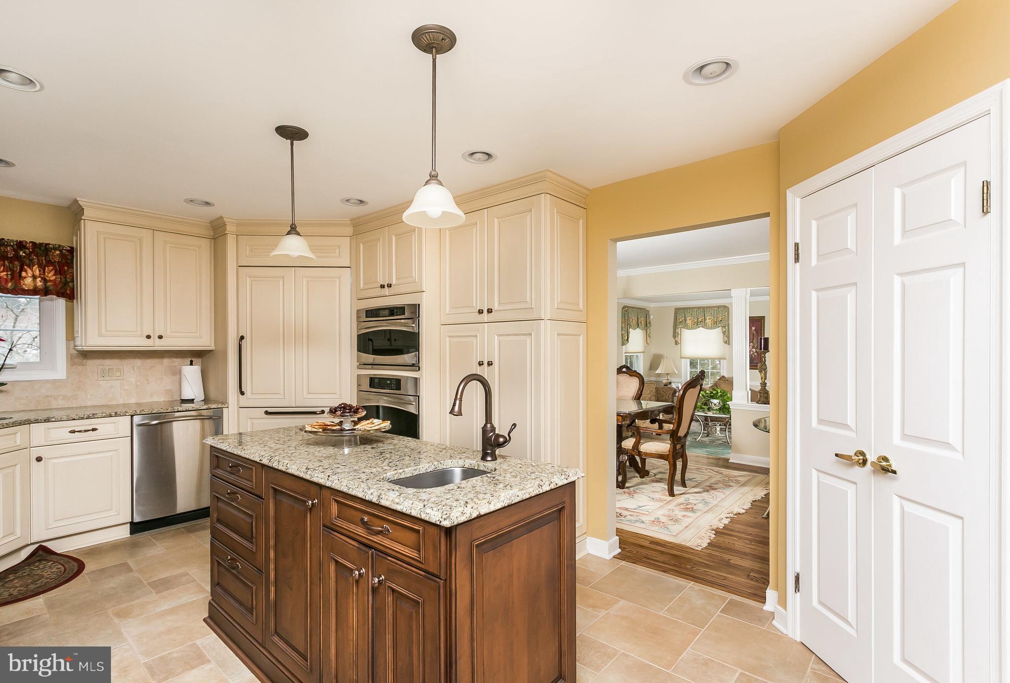 9111 Gardenia Road Baltimore, MD 21236 - Photo 10 of 30 a kitchen with a sink a stove a refrigerator and cabinets