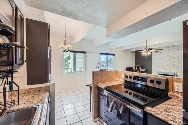a kitchen with stainless steel appliances granite countertop a stove and a refrigerator