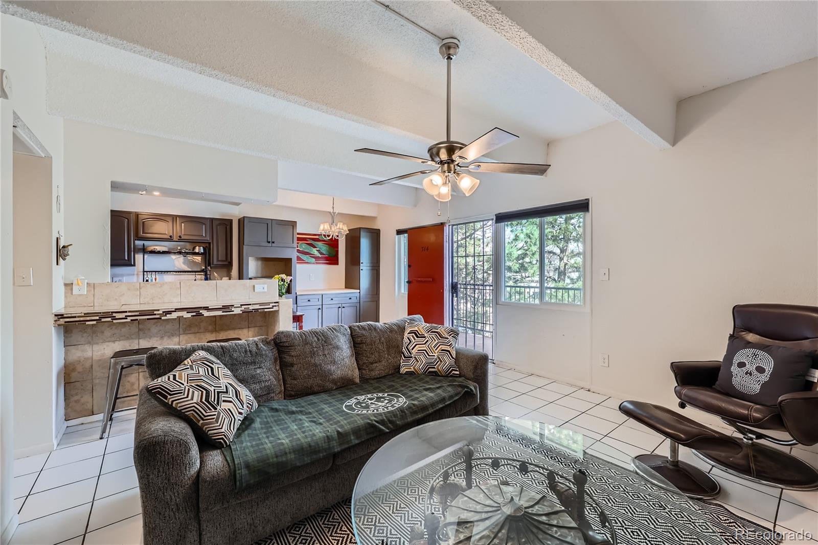 384 South Ironton Street, Unit 314 Aurora, CO 80012 - Photo 2 of 12 a living room with furniture and a flat screen tv