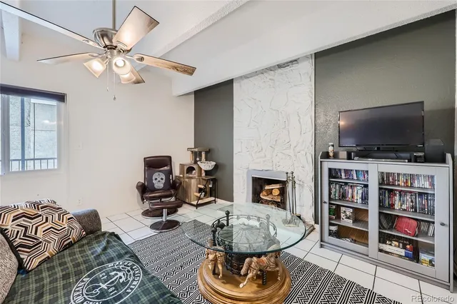 a living room with fireplace furniture and a flat screen tv