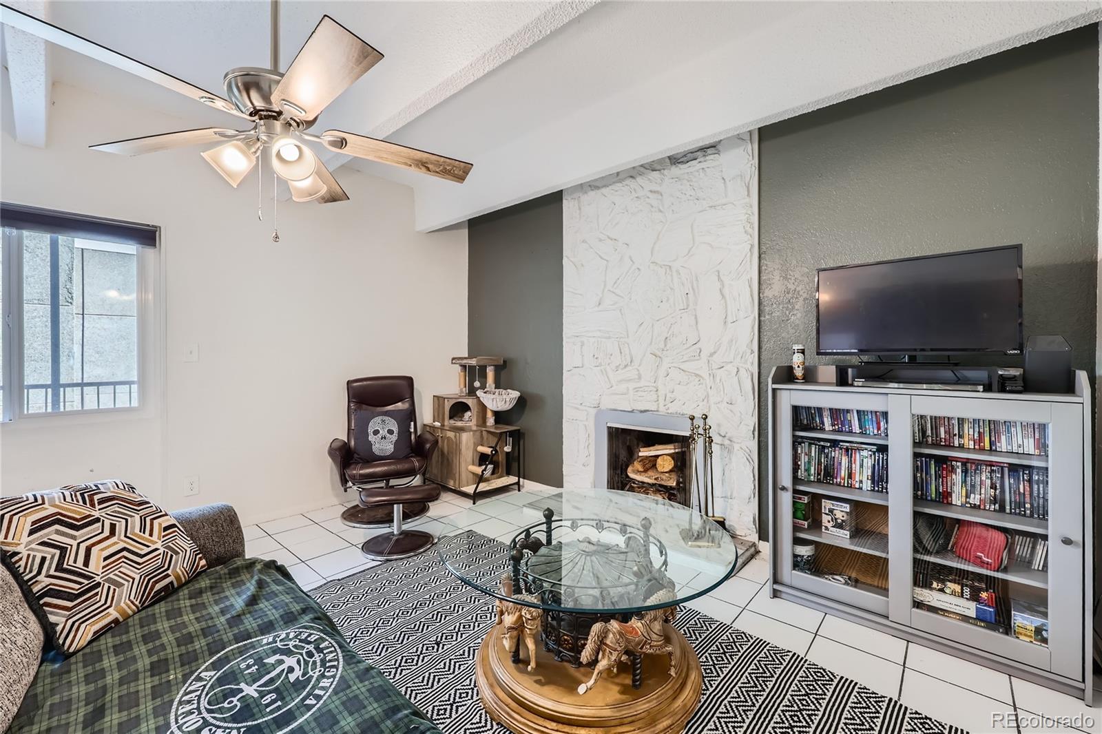 384 South Ironton Street, Unit 314 Aurora, CO 80012 - Photo 3 of 12 a living room with fireplace furniture and a flat screen tv