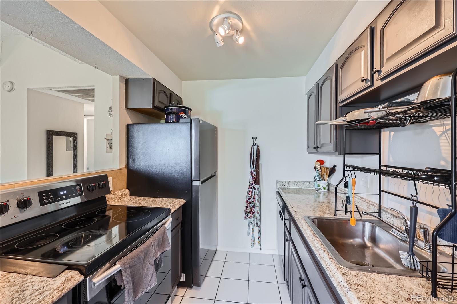 384 South Ironton Street, Unit 314 Aurora, CO 80012 - Photo 4 of 12 a kitchen with stainless steel appliances granite countertop a sink stove and refrigerator