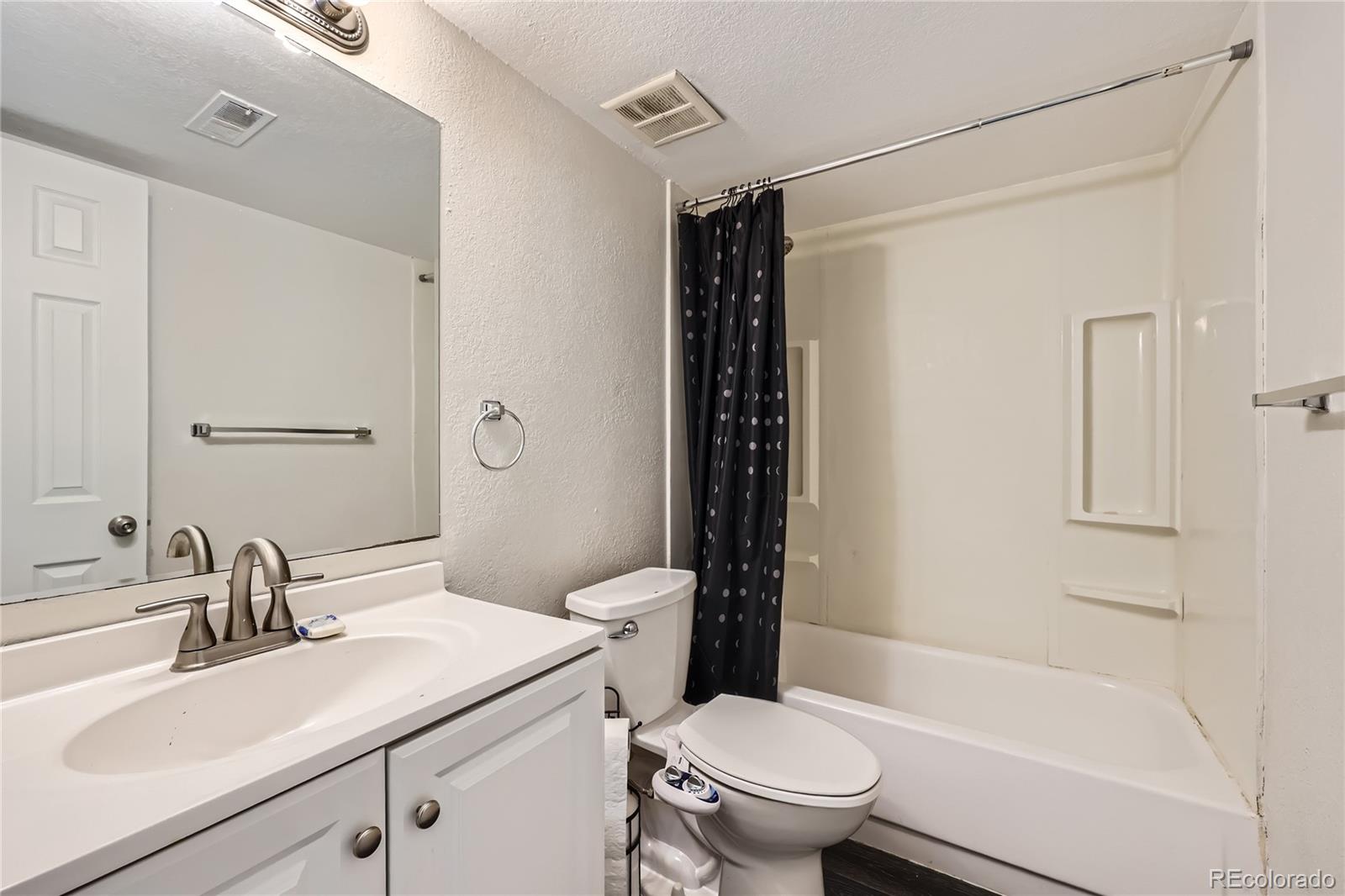 384 South Ironton Street, Unit 314 Aurora, CO 80012 - Photo 7 of 12 a bathroom with a sink toilet and shower